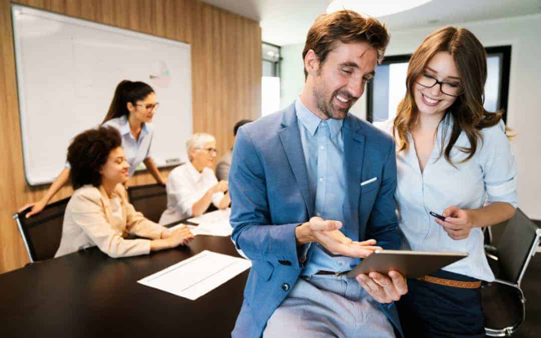 Happy business man with colleagues at a conference in office